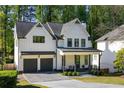 Charming two-story modern farmhouse with black framed windows and a gray driveway at 2641 Drew Valley Ne Rd, Brookhaven, GA 30319