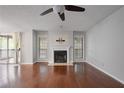 Bright living room featuring hardwood floors, a cozy fireplace, and a ceiling fan at 1244 Weatherstone Ne Dr, Atlanta, GA 30324
