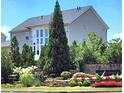 Exterior view of home with mature trees and manicured landscaping surrounding the property at 134 Sierra Cir, Woodstock, GA 30188