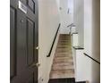 Entryway features a staircase with black handrails and modern black tile flooring at 4246 River Green Nw Dr # 202, Atlanta, GA 30327
