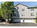 Charming townhome featuring stucco and siding, complemented by lush landscaping and a private garage at 4246 River Green Nw Dr # 202, Atlanta, GA 30327