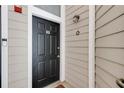 Stylish black front door with modern hardware and a secure video doorbell system at 4246 River Green Nw Dr # 202, Atlanta, GA 30327