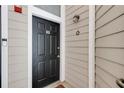 Stylish black front door with a modern doorbell and a horseshoe accent, provides a welcoming entrance at 4246 River Green Nw Dr # 202, Atlanta, GA 30327