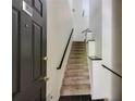Inviting entry staircase with elegant railings and tile flooring at 4246 River Green Nw Dr # 202, Atlanta, GA 30327