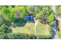 Overhead view of home on large lot surrounded by trees with long driveway leading to a paved road at 5800 S Richland Creek Rd, Buford, GA 30518