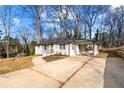 Picture of a freshly painted single-story home with a concrete driveway and attached carport at 932 Mount Airy Sw Dr, Atlanta, GA 30311