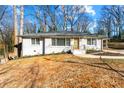 Freshly painted single-story home with a modern front door and neatly landscaped front yard is move-in ready at 932 Mount Airy Sw Dr, Atlanta, GA 30311