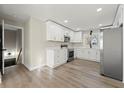 Bright kitchen with white cabinets, stainless steel appliances, and modern countertops at 932 Mount Airy Sw Dr, Atlanta, GA 30311