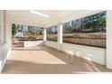 Spacious covered patio featuring white brick columns, concrete floor, and views of the yard at 932 Mount Airy Sw Dr, Atlanta, GA 30311