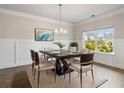 Elegant dining room featuring a modern table, chandelier, and large window at 5103 Woodline View Ln, Auburn, GA 30011