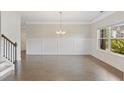 Bright dining room with hardwood floors and wainscoting, adjacent to the staircase and entry hall at 5103 Woodline View Ln, Auburn, GA 30011