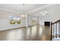 Bright living room with hardwood floors, fireplace, and large windows offering ample natural light at 5103 Woodline View Ln, Auburn, GA 30011