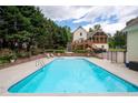 Large backyard pool surrounded by beautiful landscaping, a stone wall and plenty of room for lounge chairs at 96 Grover Way, Dallas, GA 30157