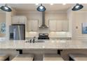 Modern kitchen featuring a spacious island with granite countertops and stainless steel appliances at 1671 Hammock Dr, Smyrna, GA 30080