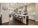 Bright kitchen with white cabinets, stainless steel appliances, and a large center island with seating at 1671 Hammock Dr, Smyrna, GA 30080