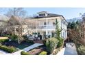 Two-story home with white exterior, covered porches, and mature landscaping at 1601 Marlbrook Ne Dr, Atlanta, GA 30307