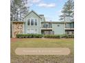 Charming exterior view of the home with an attached stone facade and a balcony with sliding glass doors at 1206 Canyon Point Cir, Roswell, GA 30076