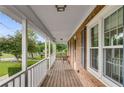 Inviting porch view highlighting brick accents, white columns, and ample space for relaxing outdoors at 1320 Pinyon Pl, Lawrenceville, GA 30043