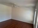 Bedroom with hardwood floors, ceiling fan, and a window allowing natural light at 240 Flowers Cove Ln, Lilburn, GA 30047