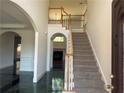 Welcoming entryway with staircase, archways, and beautiful tile flooring at 240 Flowers Cove Ln, Lilburn, GA 30047