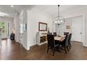 Elegant dining room featuring hardwood floors, stylish lighting fixture, and ample space for entertaining at 1074 Heyward Way, Alpharetta, GA 30009