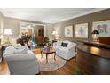 Charming living room features stylish decor, a piano, and an open doorway to the foyer at 1328 Wyntercreek Rd, Atlanta, GA 30338