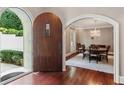 Home foyer features wood floors and a dining room visible through an arched doorway with chandelier at 1658 Mount Paran Nw Rd, Atlanta, GA 30327