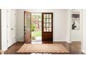 Welcoming foyer with hardwood floors, stylish rug, and views of the front yard through glass doors at 2903 Bonanza Dr, Decatur, GA 30033