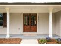 Inviting front entrance with double wooden doors, white columns, and a freshly painted facade at 2903 Bonanza Dr, Decatur, GA 30033