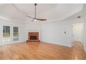 Spacious living room featuring a fireplace, hardwood floors, and access to the outdoor deck at 1721 Druids Se Xing, Conyers, GA 30013