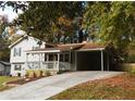 View of the home's exterior, including a long driveway and a covered carport at 727 Regina Ct, Lawrenceville, GA 30043