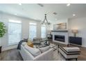 Cozy living room featuring a modern fireplace, abundant natural light, and elegant decor at 114 Iveybrooke Ln # 62, Alpharetta, GA 30009