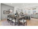 Open-concept dining area with a modern kitchen, stylish lighting, and an inviting dining table at 1765 Beckham Ne Pl # 53, Atlanta, GA 30324