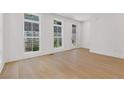 Sunlit room with hardwood floors, large windows, and a walkout door to the outside at 1765 Beckham Ne Pl # 53, Atlanta, GA 30324