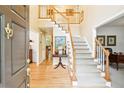 Grand two-story foyer with hardwood floors, staircase, and elegant lighting at 1894 Whitehawk Ct, Lawrenceville, GA 30043
