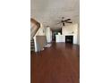 Spacious living room with hardwood floors, a fireplace, and stairs leading to the second floor at 2896 Vining Ridge Ter, Decatur, GA 30034