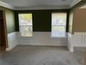 Inviting living room featuring carpet, classic wainscoting, and plenty of natural light at 4234 Winston Cir, Atlanta, GA 30349