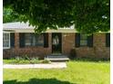 Brick home featuring a welcoming front entrance and manicured lawn at 724 Camelot Way, Norcross, GA 30071