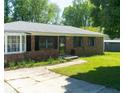 Well-maintained brick home with a bay window and a lush green lawn at 724 Camelot Way, Norcross, GA 30071