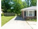 This brick home has a charming bay window and well-maintained landscaping at 724 Camelot Way, Norcross, GA 30071