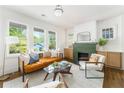 Bright living room with large windows, a decorative fireplace, and stylish furnishings at 1395 Hartford Sw Ave, Atlanta, GA 30310