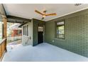 Inviting covered porch with a ceiling fan, railing, and painted brick exterior at 1395 Hartford Sw Ave, Atlanta, GA 30310