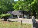 Cozy home with a covered porch, nestled among trees at 165 Holly Ct, Loganville, GA 30052
