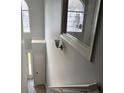 Bright hallway featuring a window, light fixture, and doors at 4817 Hidden Creek Place, Decatur, GA 30035
