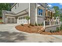 Stunning two-story home with a 2-car garage, stone accents, and professionally landscaped front yard at 1005 Liberty Springs Dr, Woodstock, GA 30188