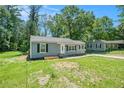 Charming single-story home featuring gray siding, black shutters, and a welcoming front door at 4135 Brenda Dr, Decatur, GA 30035