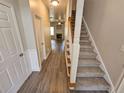 Inviting entryway with hardwood floors and carpeted stairs leading to the upper level at 4316 Sw Notting Hill Sw Dr, Atlanta, GA 30331