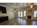 Bright living room with fireplace, hardwood floors, and French doors to the exterior at 4316 Sw Notting Hill Sw Dr, Atlanta, GA 30331