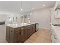 Gourmet kitchen boasts stainless appliances, a large center island, and lots of natural light at 1025 Liberty Springs Dr, Woodstock, GA 30188