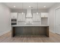 Bright, open kitchen featuring a large island, modern white cabinets and stainless steel appliances at 1025 Liberty Springs Dr, Woodstock, GA 30188